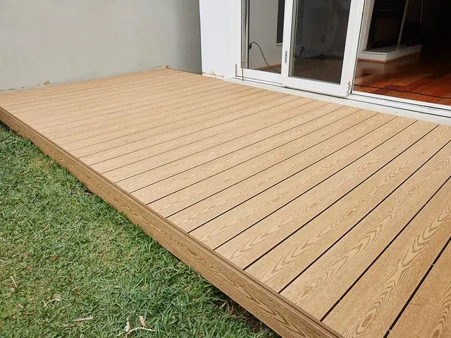 Wood composite deck installed outside a home.